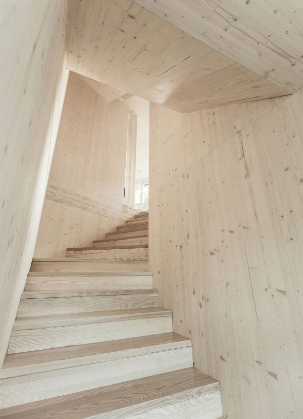 52 Kubik is an office building combining a mirrored base with a wooden upper floor