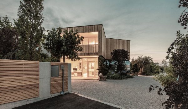 52 Kubik is an office building combining a mirrored base with a wooden upper floor