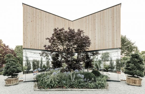 52 Kubik is an office building combining a mirrored base with a wooden upper floor