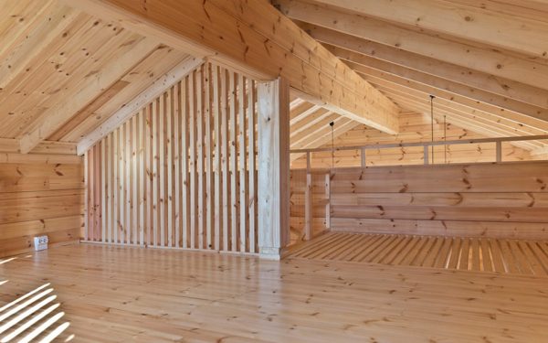 Lake cabin by Sini Kamppari features slatted timber siding and projecting terrace