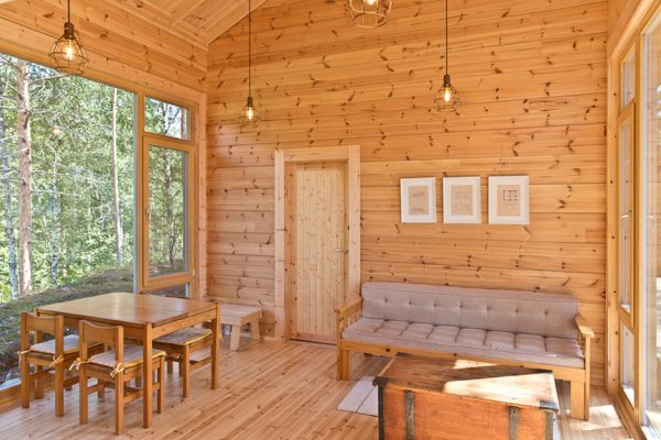 Lake cabin by Sini Kamppari features slatted timber siding and projecting terrace