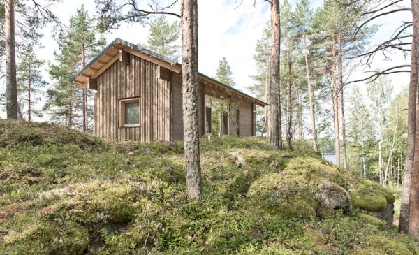 Lake cabin by Sini Kamppari features slatted timber siding and projecting terrace