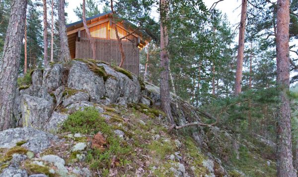 Lake cabin by Sini Kamppari features slatted timber siding and projecting terrace