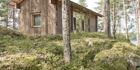 Lake cabin by Sini Kamppari features slatted timber siding and projecting terrace