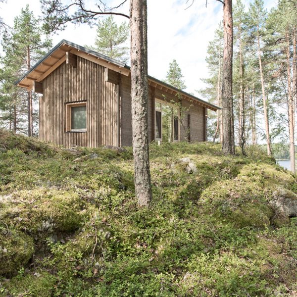 Lake cabin by Sini Kamppari features slatted timber siding and projecting terrace