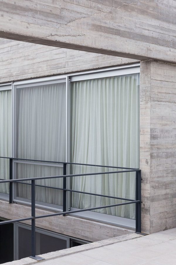Textured concrete walls frame lake views from Buenos Aires house by Federico Sartor