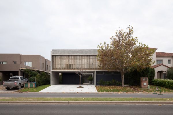 Textured concrete walls frame lake views from Buenos Aires house by Federico Sartor