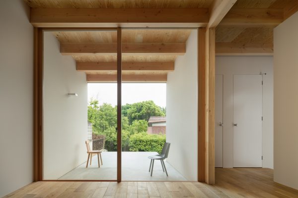 House in Mikage by Sides Core contrasts white surfaces with exposed wooden beams