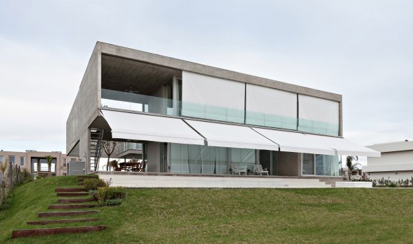 Moarqs and Ottolenghi Architects wrap Lamas House with concrete screen