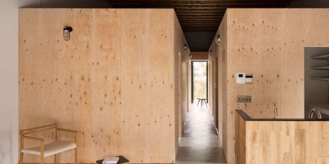 Wooden boxes define rooms and mezzanines in Loft House by CAPD