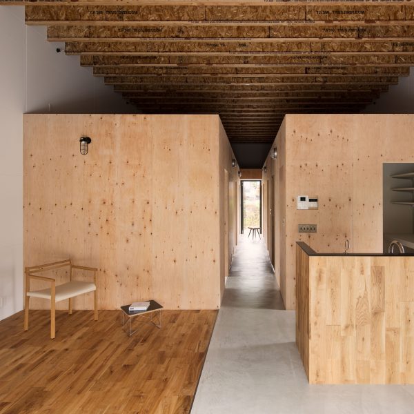 Wooden boxes define rooms and mezzanines in Loft House by CAPD