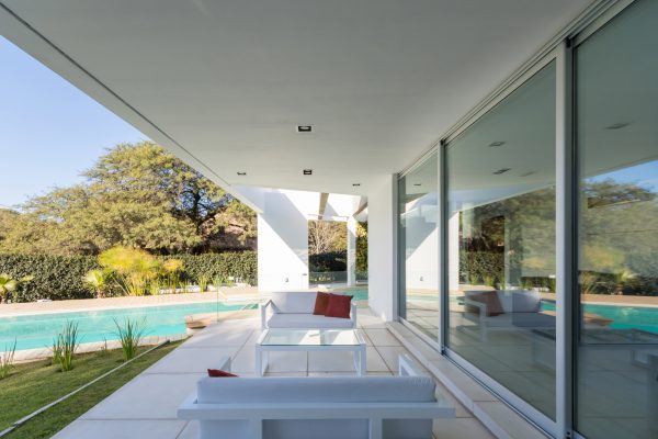 FCP Arquitectura Mooe House contrasts solid white walls with perforated iron screens