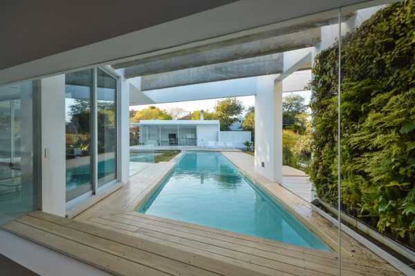 FCP Arquitectura Mooe House contrasts solid white walls with perforated iron screens