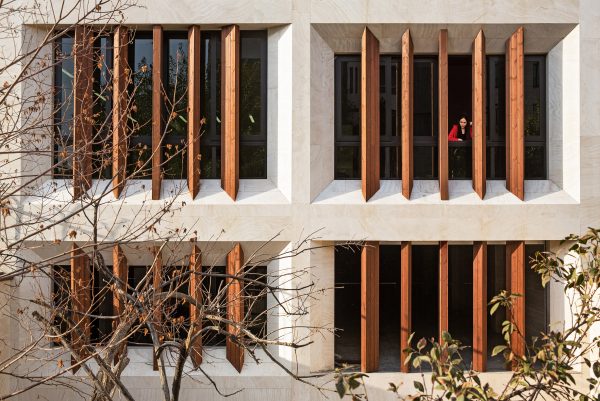 Tehran office building features facade divided into a grid of faceted window frames