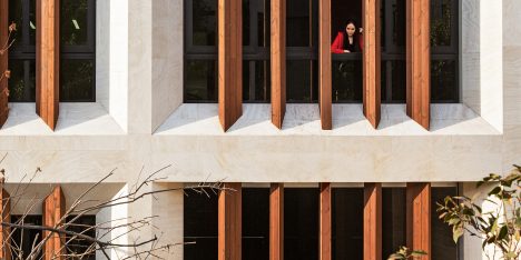Tehran office building features facade divided into a grid of faceted window frames