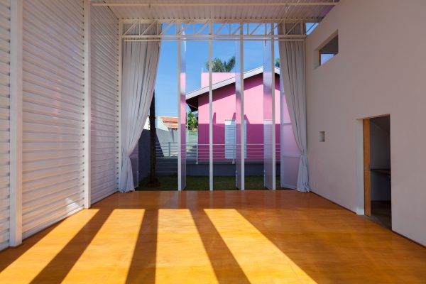 Alan Chu incorporates stage with giant doors into a home for a Brazilian actor