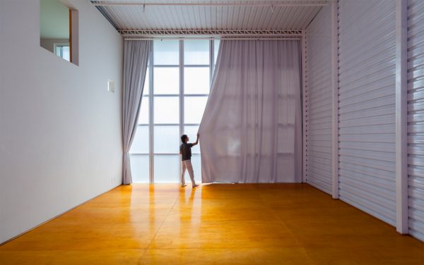 Alan Chu incorporates stage with giant doors into a home for a Brazilian actor