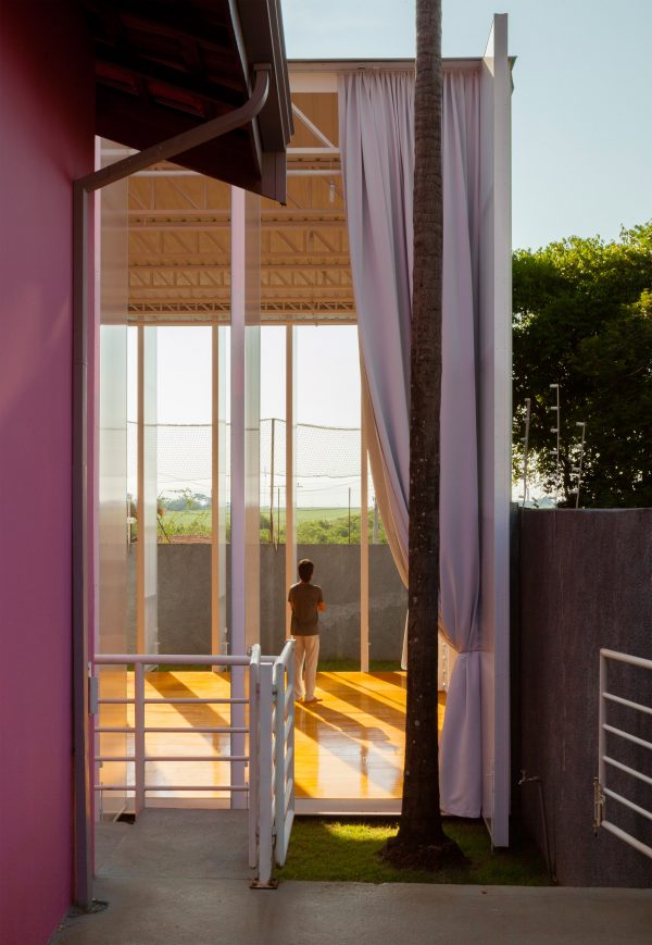 Alan Chu incorporates stage with giant doors into a home for a Brazilian actor