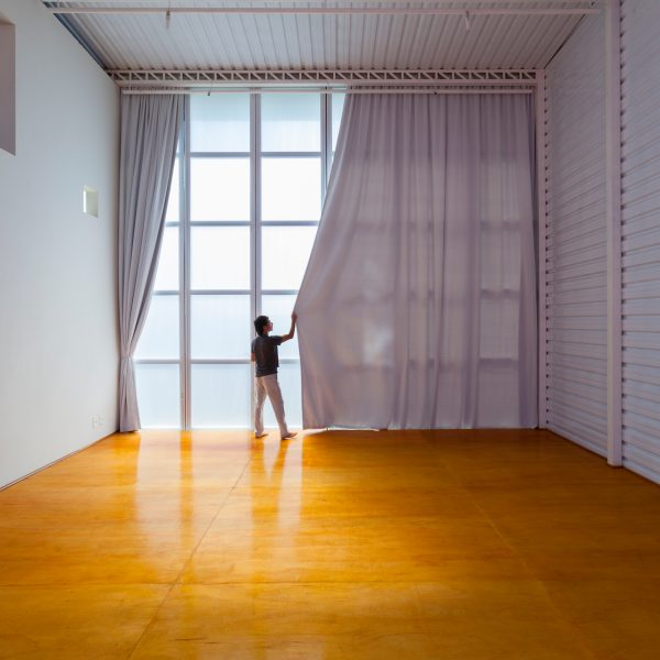 Alan Chu incorporates stage with giant doors into a home for a Brazilian actor