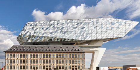 “Giant glass grasshoppermates with building”