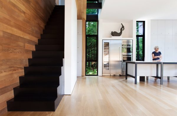 YH2 clads a Quebec holiday home for a sculptor in red cedar and blackened pine