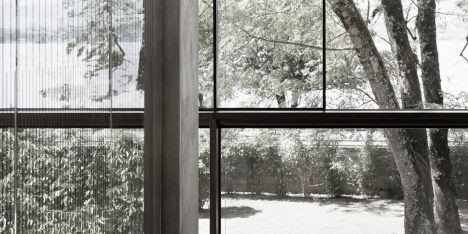 Villa Le Lac is a glass-walled house overlooking Lake Geneva