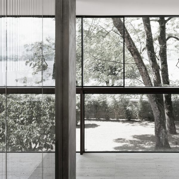 Villa Le Lac is a glass-walled house overlooking Lake Geneva