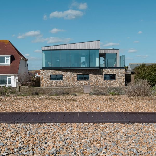 Shoreham Beach House by ABIR Architects features gabion walls filled with beach pebbles
