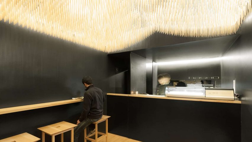 Paulo Merlini suspends chopsticks from ceiling of minimal sushi bar