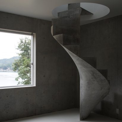 Chunky concrete staircase spirals through House in Akitsu by Kazunori Fujimoto