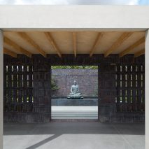 Colonnades frame landscaped courtyards at Buddhist retreat in rural England
