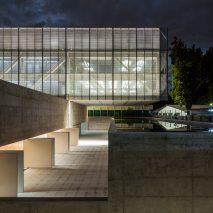 Glazed block cantilevers over reflecting pool at Brasília offices by Mira Arquitetos