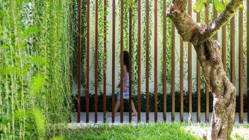 MIA Design Studio envelopes Vietnam house in plant-covered walls and courtyards