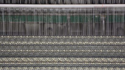 Loom weaving vinyl thread together with other textiles such as wool or cotton