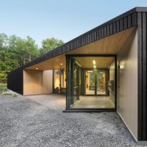 Dark cedar boards shroud Quebec visitors centre by Anne Carrier