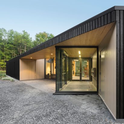 Dark cedar boards shroud Quebec visitors centre by Anne Carrier