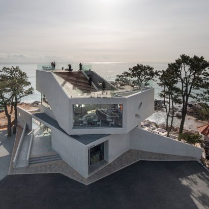 Stacked concrete blocks and roof deck give diners sea views from South Korean cafe