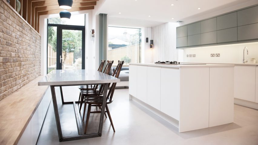Brick house extension by Studio 1 features garden-facing window seat