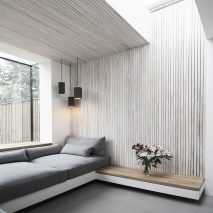 Brick house extension by Studio 1 features garden-facing window seat