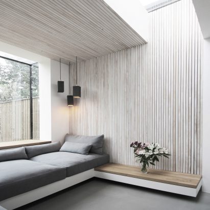 Brick house extension by Studio 1 features garden-facing window seat