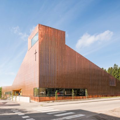 Copper covers walls and roof of Finnish chapel by OOPEAA