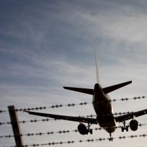 Plane Flying Over Fence