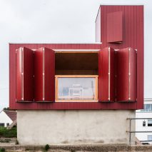Red beach hut by Jonathan Hendry Architects stands atop former toilet block