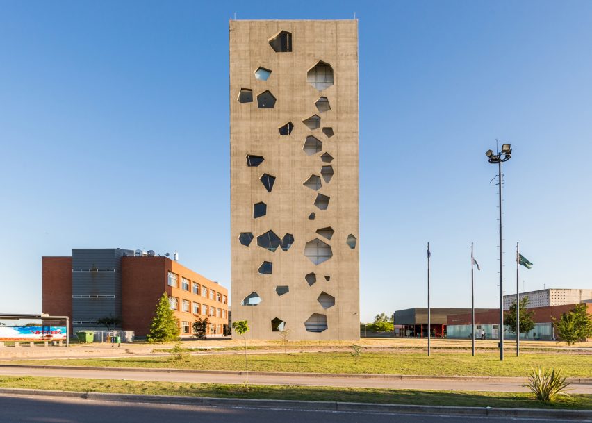 Angular openings puncture concrete facades of university tower by Morini Arquitectos