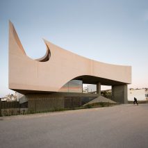 Huge circular hole pierces concrete house in Crete by Tense Architecture Network
