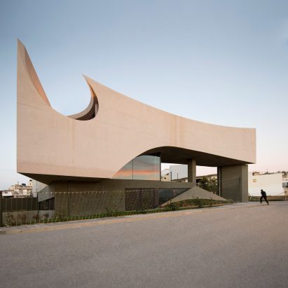 Huge circular hole pierces concrete house in Crete by Tense Architecture Network