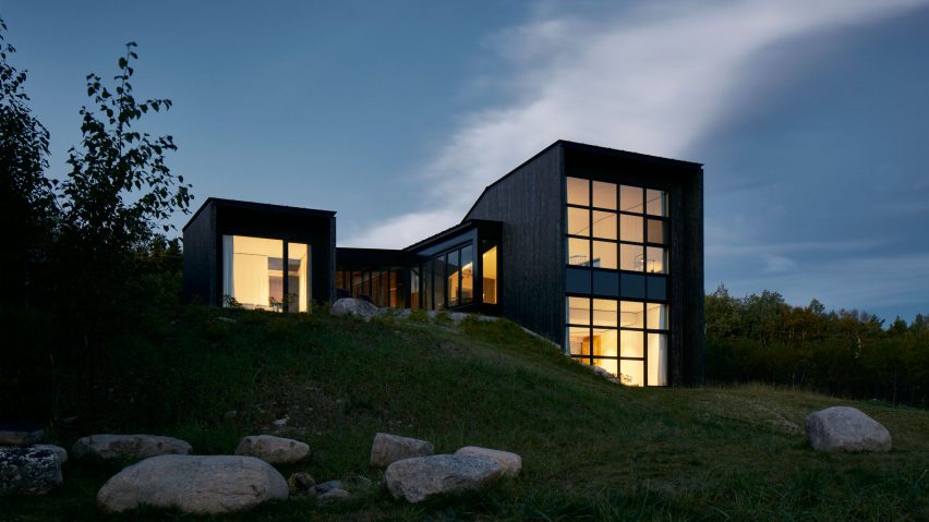 Burnt cedar clads mountainside home in Quebec by Alain Carle
