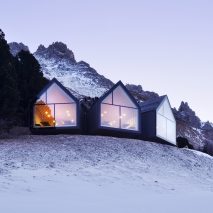 Three blackened wood huts project from mountain restaurant by Peter Pichler and Pavol Mikolajcak