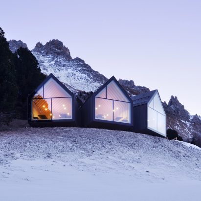 Three blackened wood huts project from mountain restaurant by Peter Pichler and Pavol Mikolajcak
