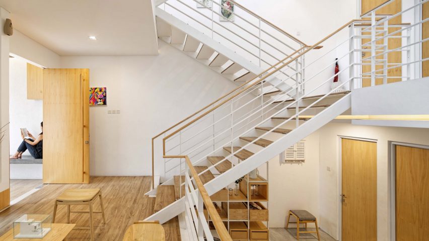 Multiple mezzanines are connected by an open stair in Delution Architect’s Jakarta house